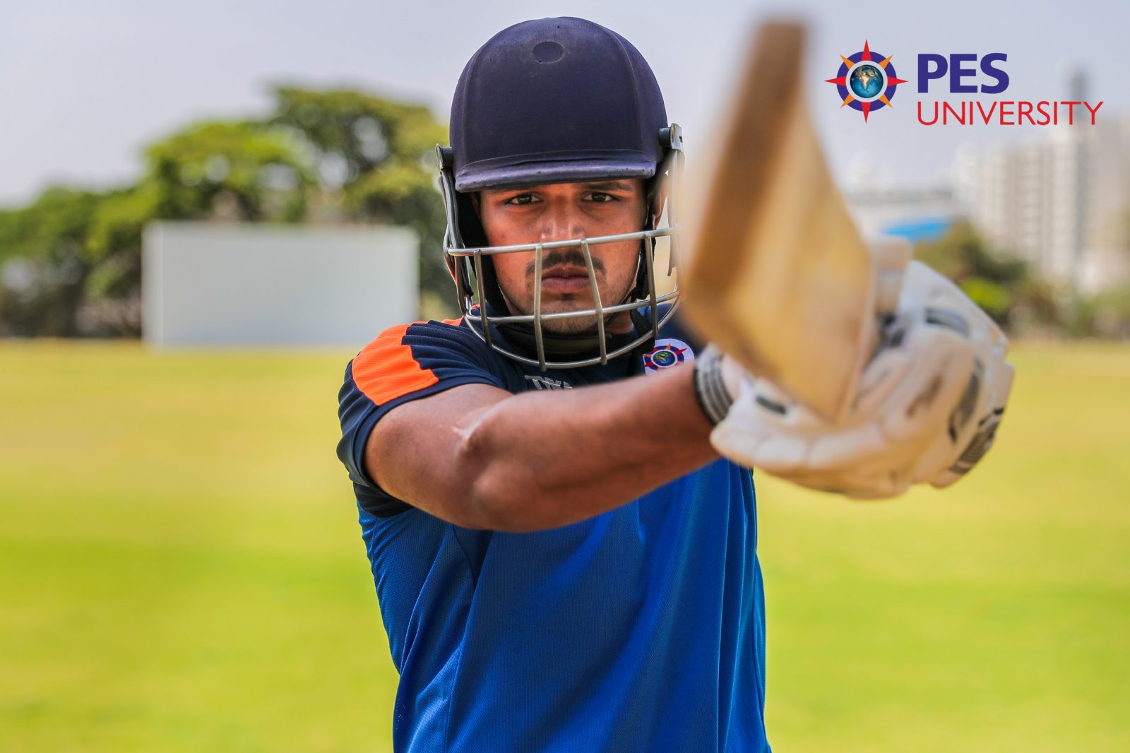 Cover: a cricketer mid-shot with the PES University mark